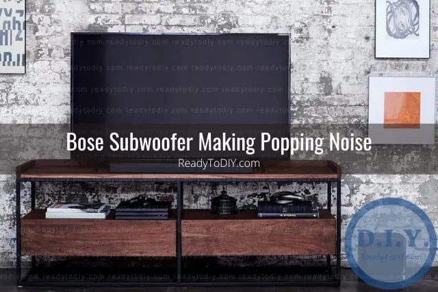 Black subwoofer below the flatscreen tv