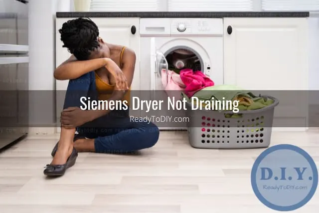 Confused woman sitting with clothes on the floor
