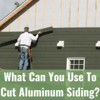 Man fixing the siding of the house