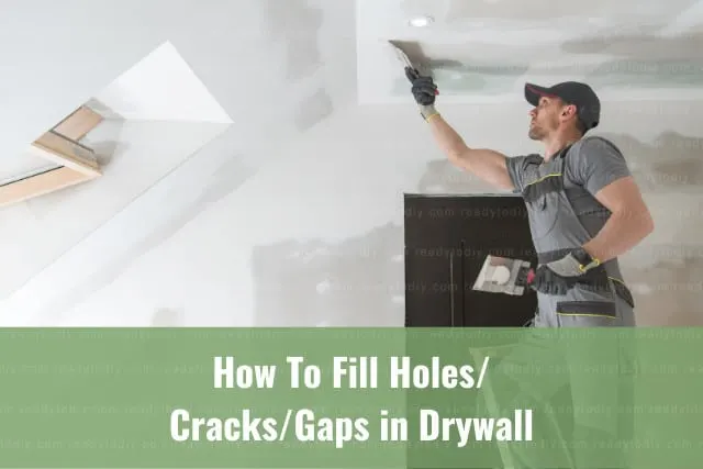 Man fixing the drywall