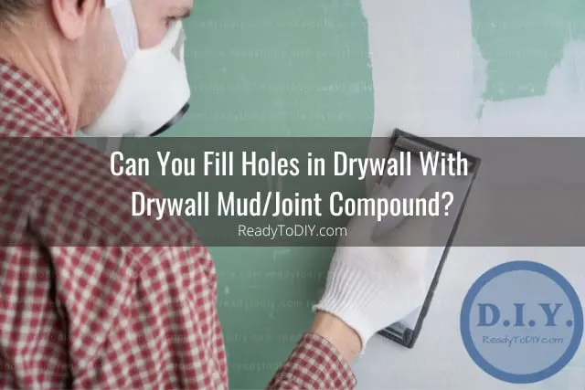 Man fixing the drywall