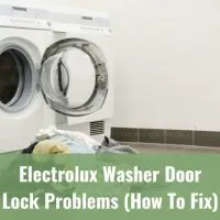 White modern washer with clothes inside