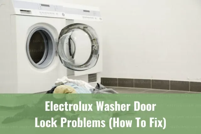 White modern washer with clothes inside