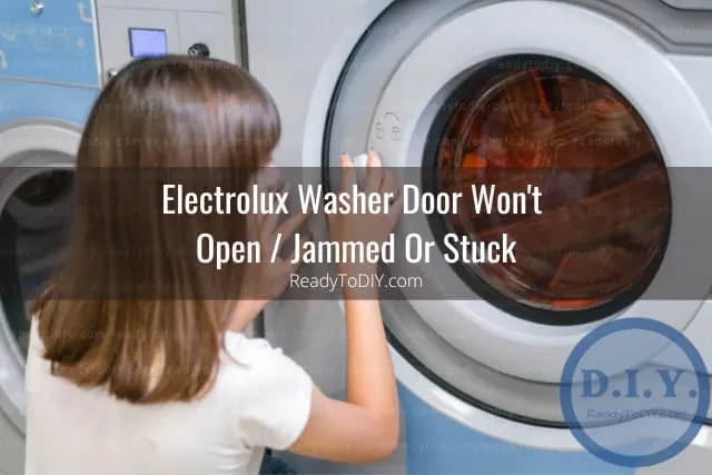 White modern washer with clothes inside