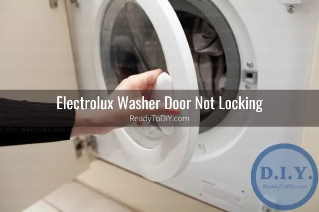 White modern washer with clothes inside