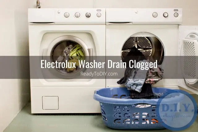 White modern washer with clothes inside