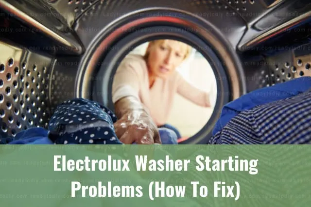 White modern washer with clothes inside