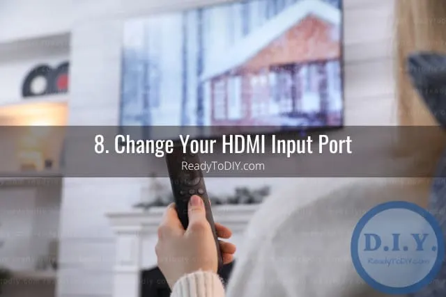 Holding a remote while point at the tv