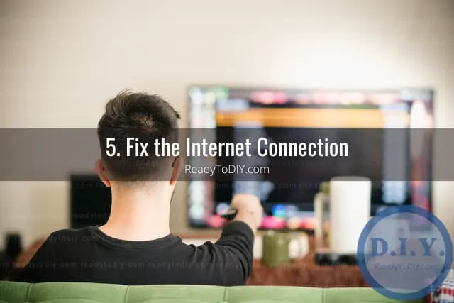 Holding a remote while point at the tv