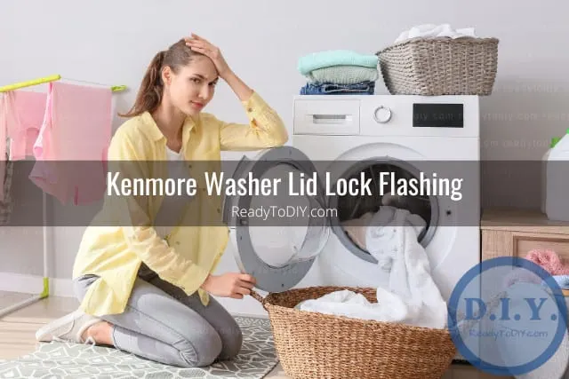 White modern washer with clothes inside