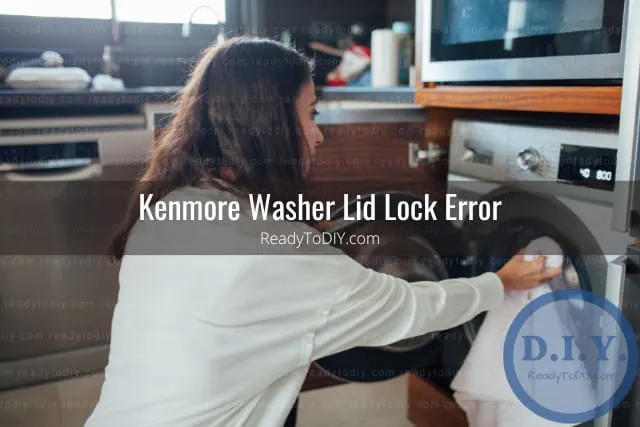 White modern washer with clothes inside