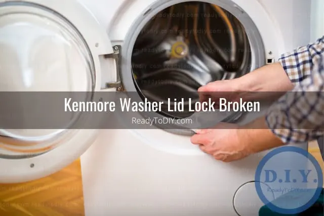 White modern washer with clothes inside