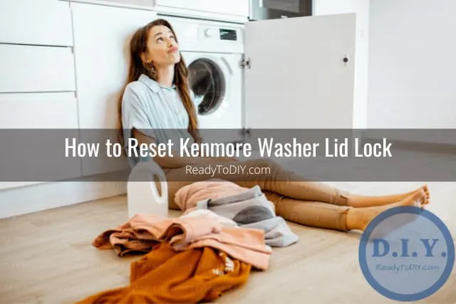 White modern washer with clothes inside