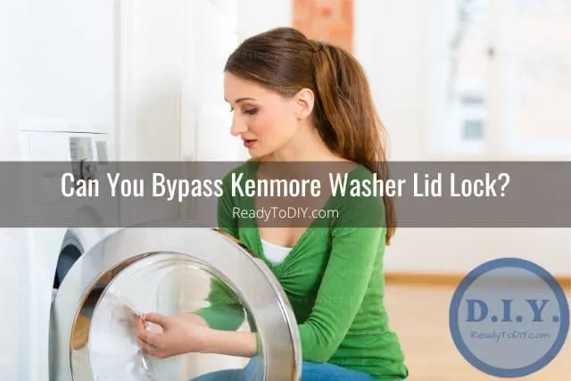 White modern washer with clothes inside