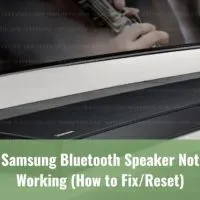 Black modern speaker below the flatscreen tv