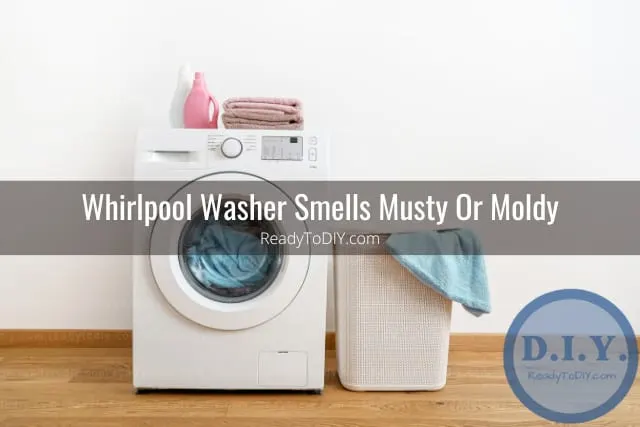 White modern washer with clothes