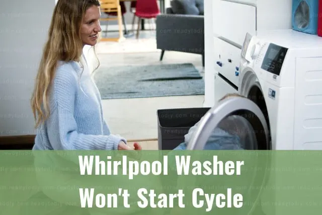 Modern white washer with clothes inside
