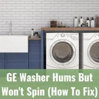 Modern white washer with clothes inside