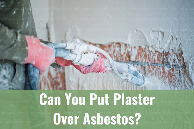Man putting plaster on the wall