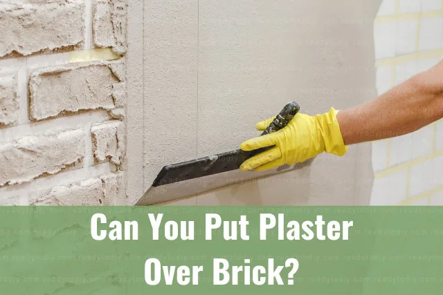 Man putting plaster on the wall