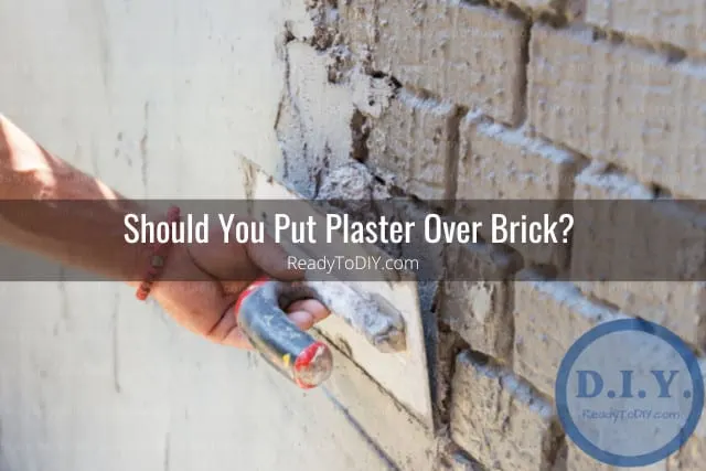 Man putting plaster on the wall