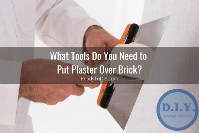 Man putting plaster on the wall