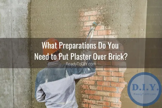 Man putting plaster on the wall