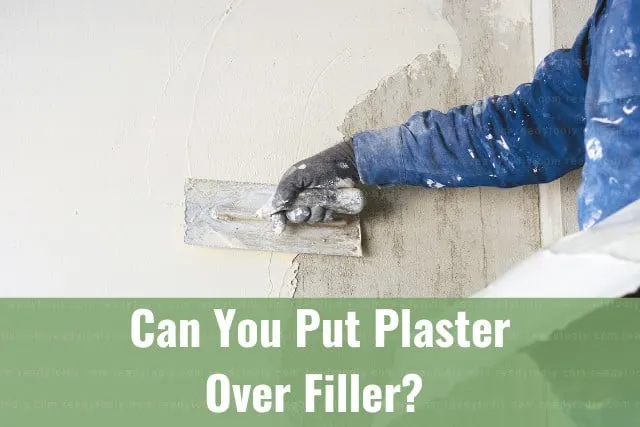 Man putting plaster on the wall