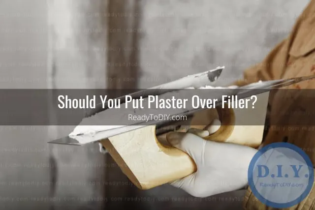 Man putting plaster on the wall