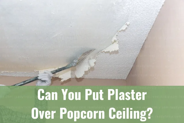 Man removing popcorn ceiling