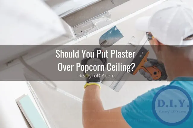 Man putting plaster on the wall
