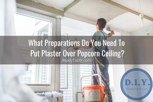 Man putting plaster on the wall