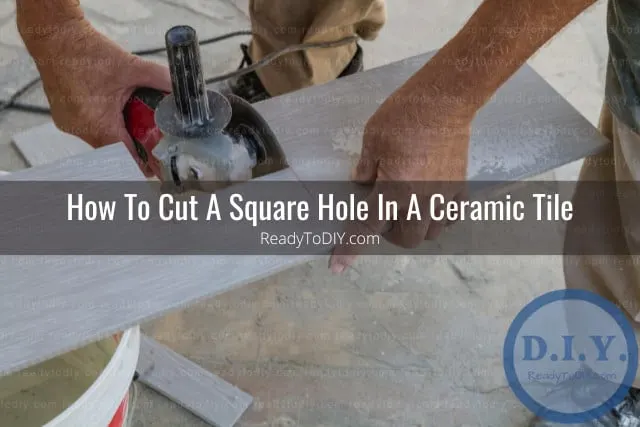 Man cutting ceramic tile in hole