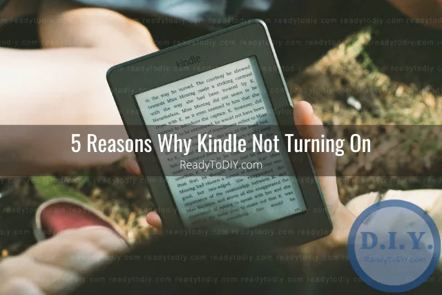 Holding black kindle while reading