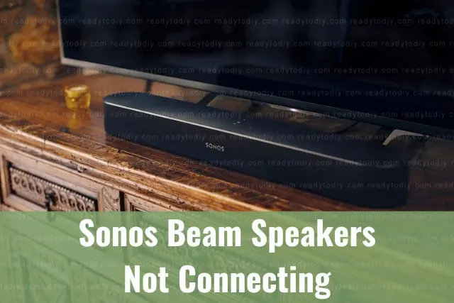 Black latest speaker below flatscreen tv