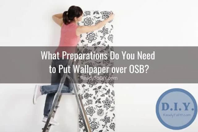 Woman installing wallpaper
