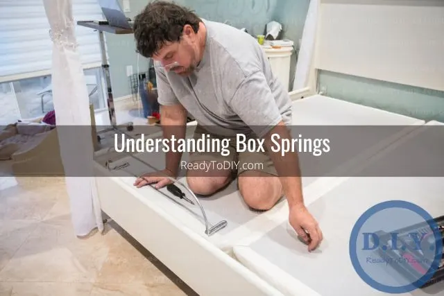 Man setting up bed box spring frame